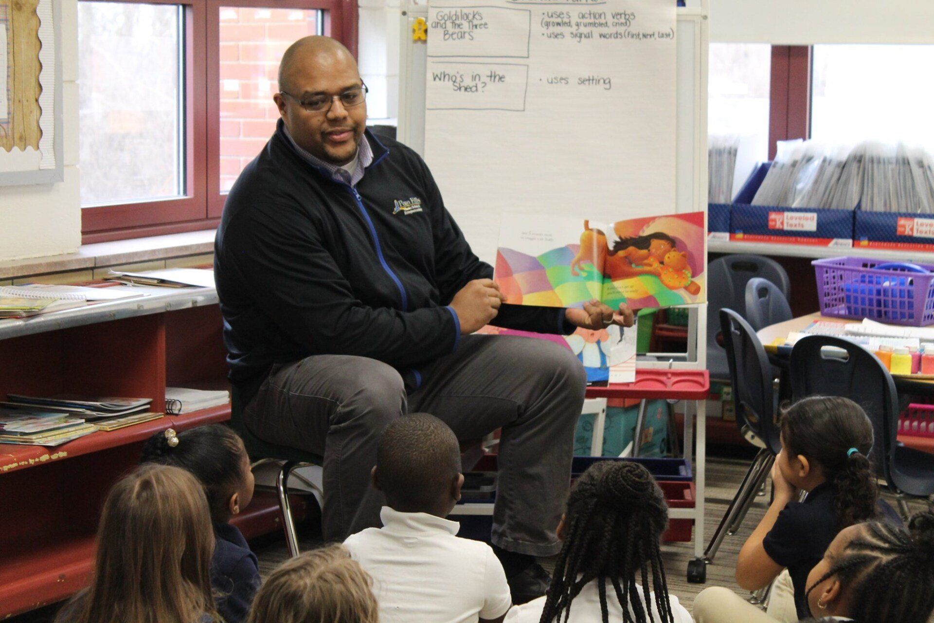 A PHCSE teacher working with students in the classroom