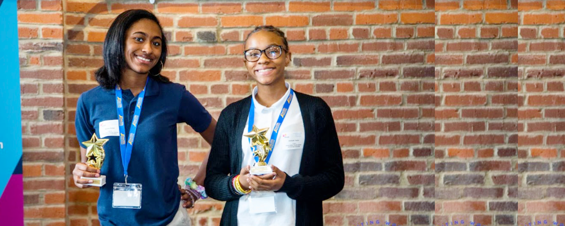 PHCSE students holding awards at an enrollment event